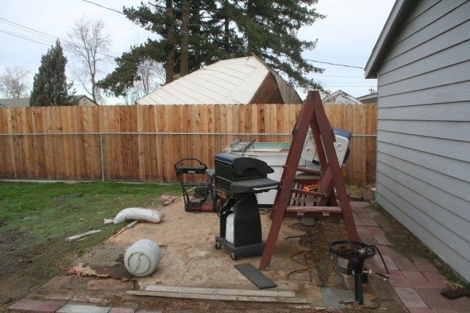 These items were once stored in the shed. The shed is behind the fence.